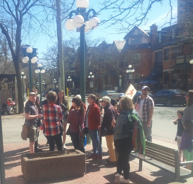 Participants of the walk on Building Accessible Cities note how street furniture such as benches, bollards, and transit shelters are arranged in pedestrian spaces. 