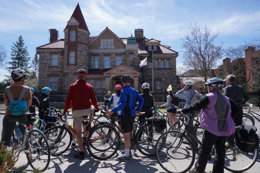 Participants on this year's bike tour view Fleck-Patterson House on Wilbrod St. near the Rideau River, now part of the Embassy of Algeria.
