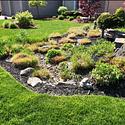 This rain garden provides an area with pebble mulch and contouring that help keep rainwater from becoming run-off before it can be absorbed.. 