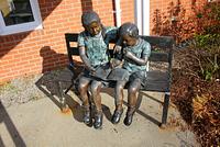 Bronze sculpture of young readers at the Manotick Public Library